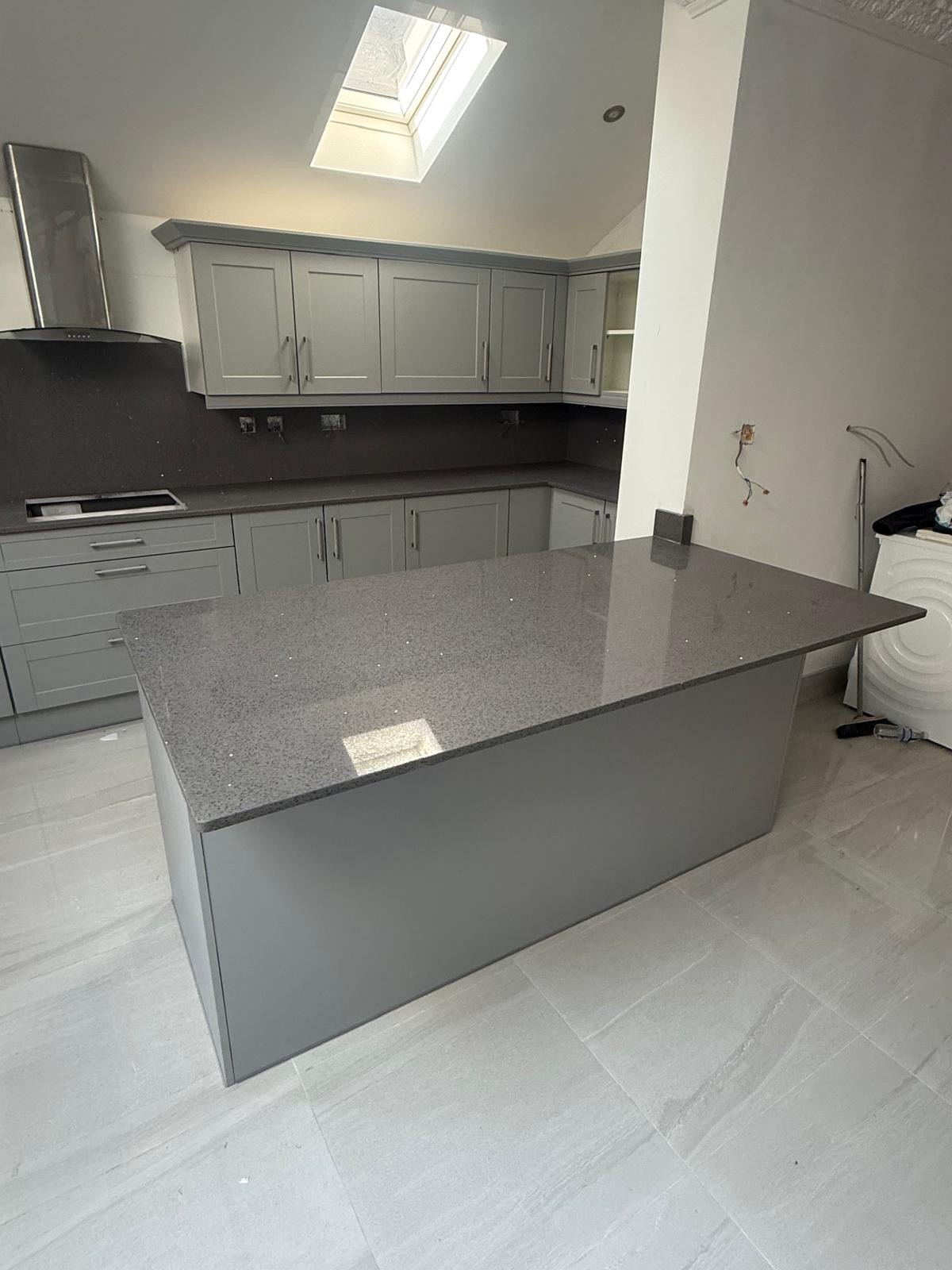 Sparkle grey quartz island and worktops in modern grey kitchen
