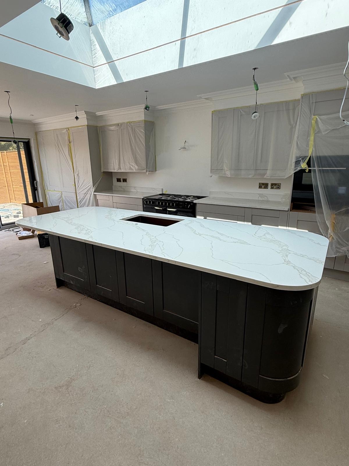 Curved calacatta quartz island in classic shaker kitchen