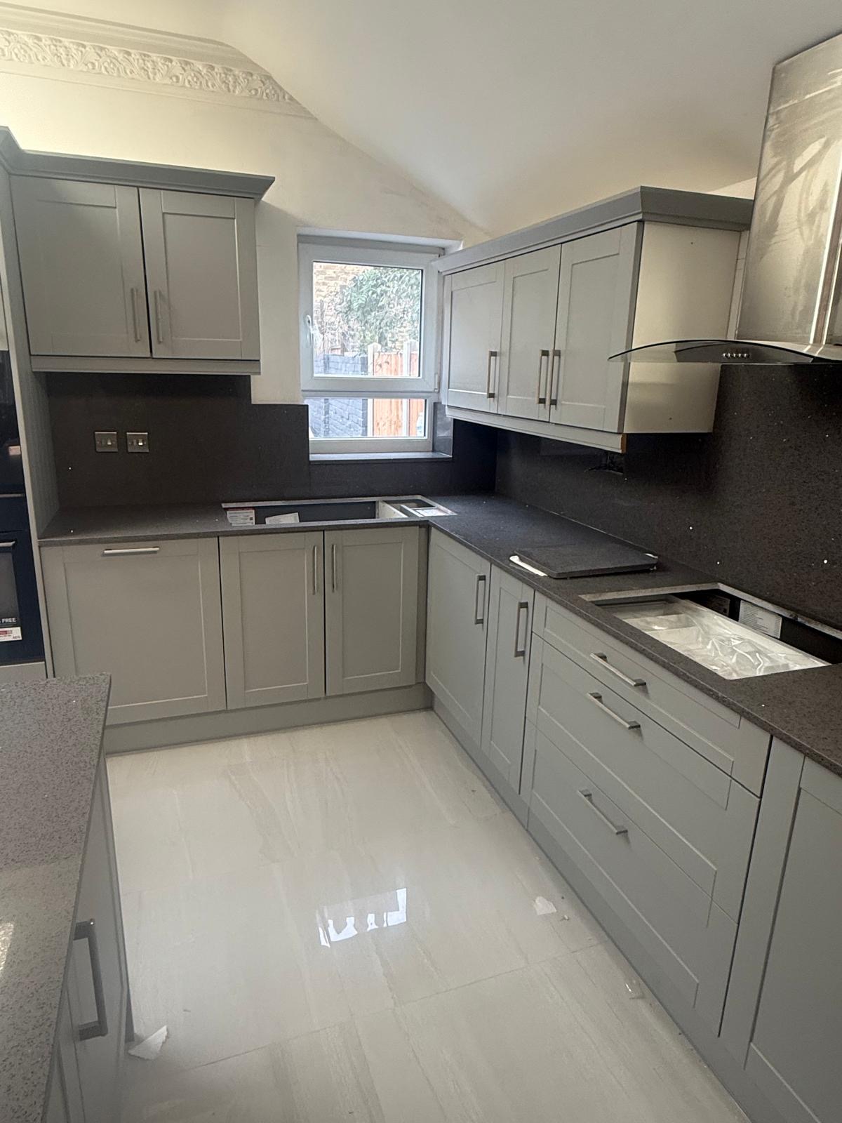 Black granite worktops with grey shaker cabinets